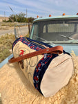 Canvas duffel bag with floral pattern on a truck bed
