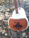Our Rodeo Gear Bag measures 24"x12". This bag is built from our heavy 15 ounce canvas, has a #10  brass zipper, handles with a leather grip, leather shoulder strap and two leather end pockets that can be customized.