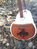 Our Rodeo Gear Bag measures 24"x12". This bag is built from our heavy 15 ounce canvas, has a #10  brass zipper, handles with a leather grip, leather shoulder strap and two leather end pockets that can be customized.