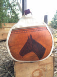 Our Rodeo Gear Bag measures 24"x12". This bag is built from our heavy 15 ounce canvas, has a #10  brass zipper, handles with a leather grip, leather shoulder strap and two leather end pockets that can be customized.