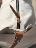 Our Rodeo Garrett bags are constructed from our heavy 15 ounce canvas, two end pockets, a stout brass zipper, leather gripper, with snaps, on the handles. A leather shoulder strap, which can be personalized.