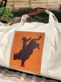 Our Rodeo Garrett bags are constructed from our heavy 15 ounce canvas, two end pockets, a stout brass zipper, leather gripper, with snaps, on the handles. A leather shoulder strap, which can be personalized