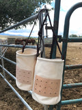 Our Morale Feed Bags are built with our heavy duty, 15 oz canvas. They have a double reinforced bottom, a leather and screen vent to allow air to flow into the bag, and an adjustable leather strap.