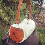 Our Rodeo Gear Bag measures 24"x12". This bag is built from our heavy 15 ounce canvas, has a #10  brass zipper, handles with a leather grip, leather shoulder strap and two leather end pockets that can be customized.