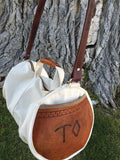 Our Rodeo Gear Bag measures 24"x12". This bag is built from our heavy 15 ounce canvas, has a #10  brass zipper, handles with a leather grip, leather shoulder strap and two leather end pockets that can be customized.